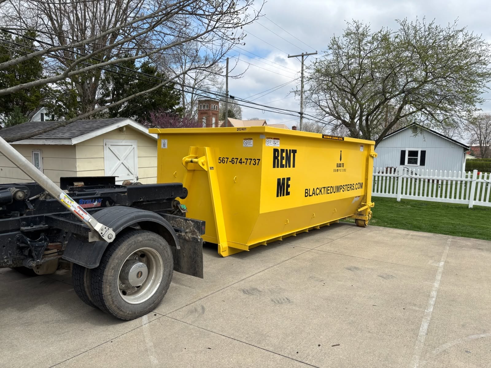 20 yard Black Tie Dumpsters roll-off dumpster delivered to a driveway